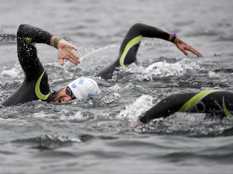 Group of people swimming in open water